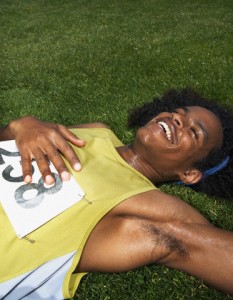 Male track athlete relaxing after race