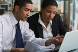 Businessman and businesswoman reviewing paperwork