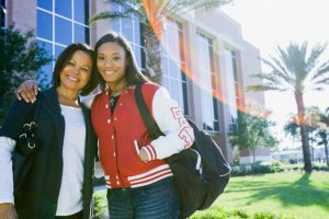 Portrait of smiling female African American college student and mother