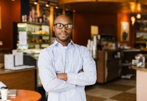 Black man standing in coffee shop