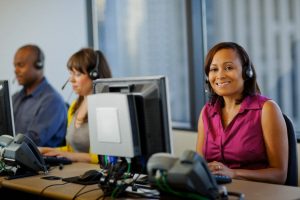 Business people working on computers in call center